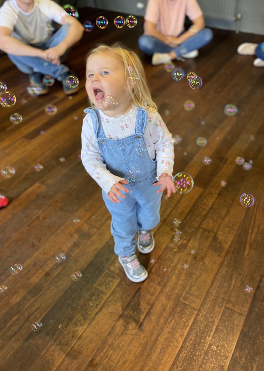 Girl catching bubbles