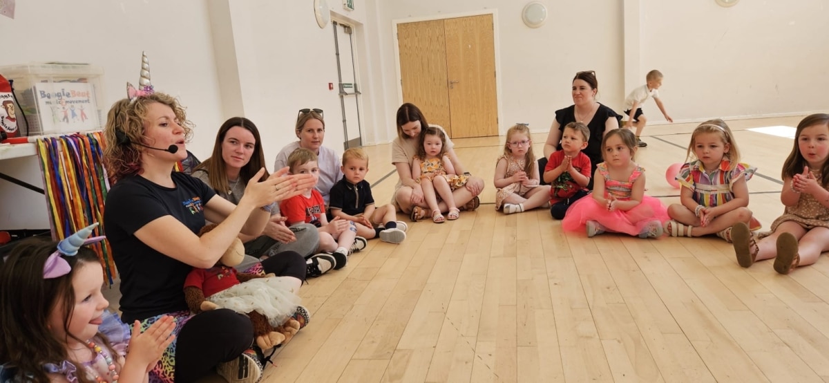 Children sat in circle taking part in activity