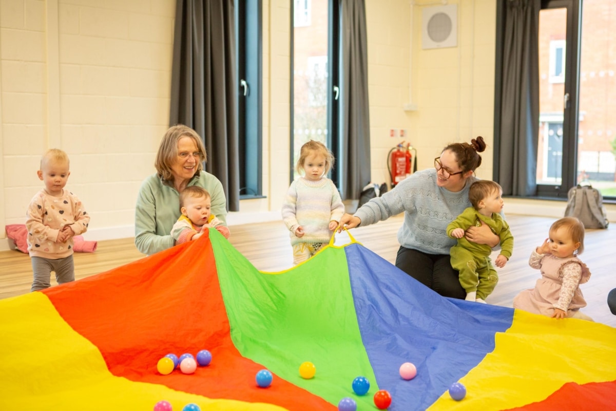 parents and children with parachute