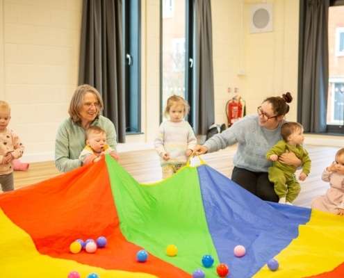 parents and children with parachute