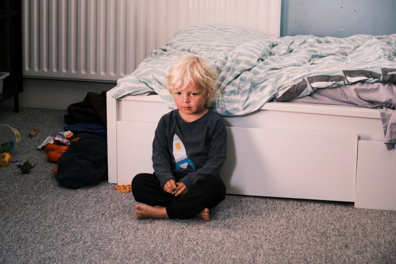 Picture of a child sat next to bed