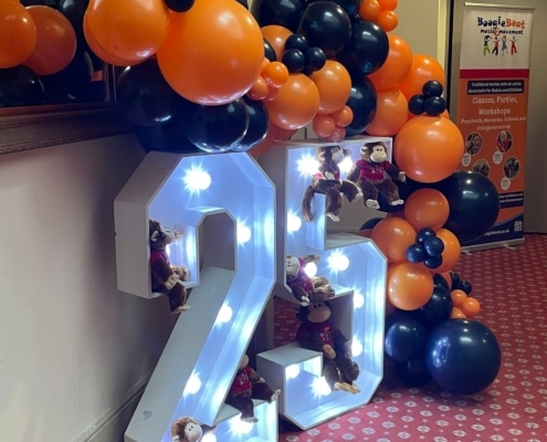 light up 25 numbers and orange and blue balloon arch