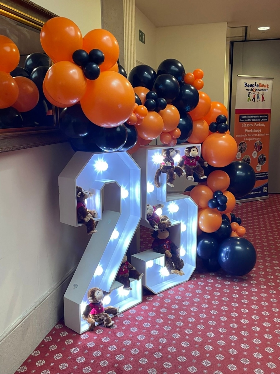 light up 25 numbers and orange and blue balloon arch