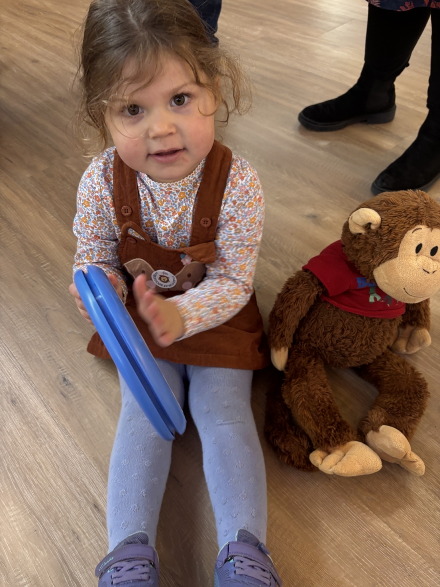girl playing with a drum in a boogie beat class