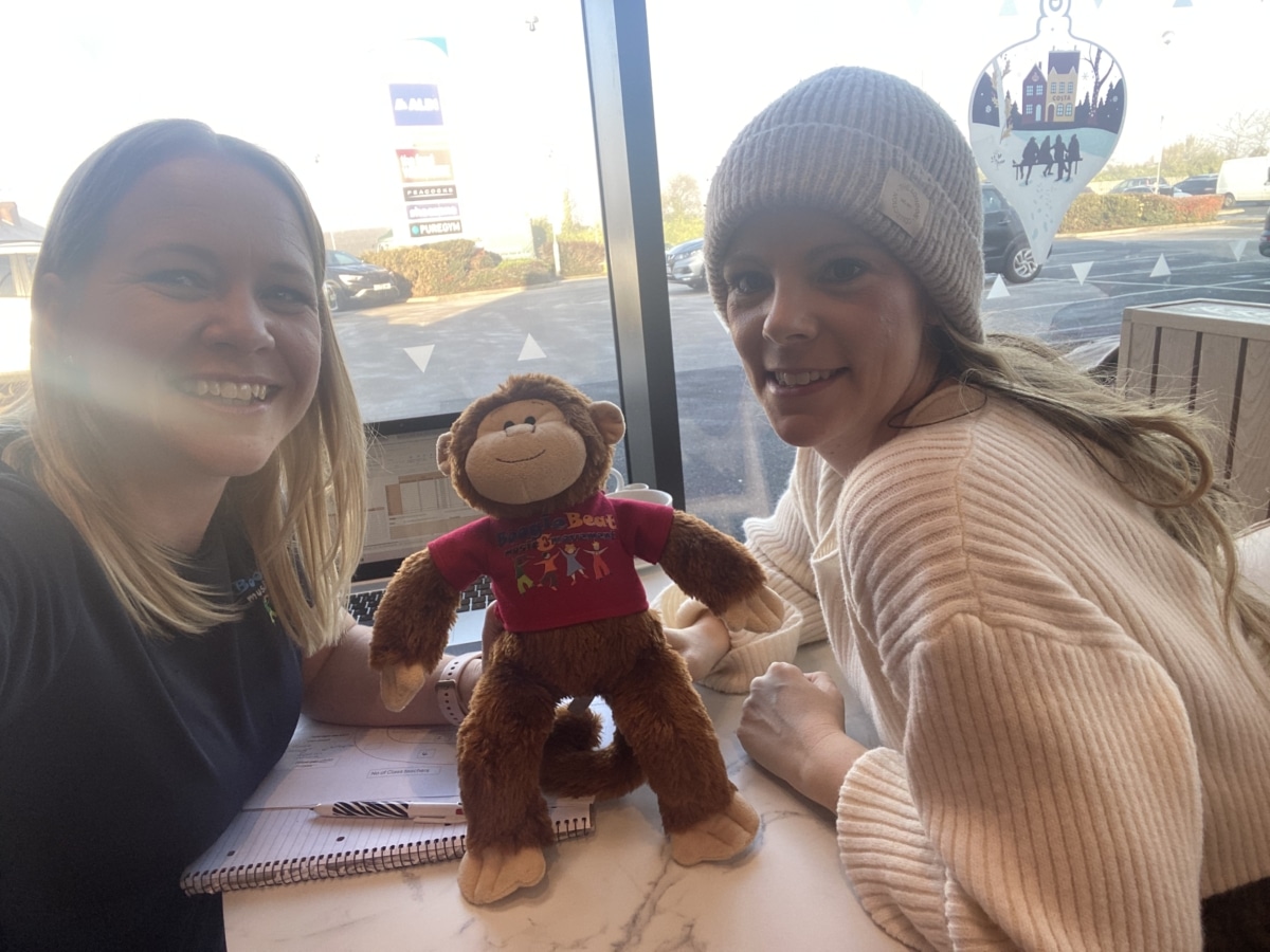 2 ladies one with blonde hair and one wearing a hat with a monkey