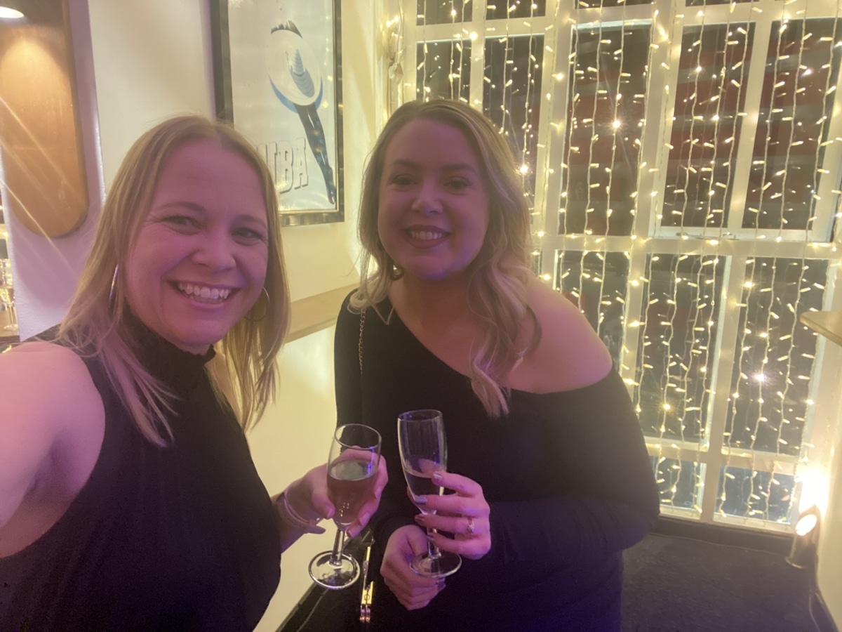 2 ladies with blonde hair and celebrating at an event