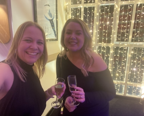 2 ladies with blonde hair and celebrating at an event